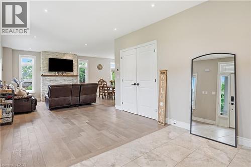 Open-concept living area with wood-finish flooring, recessed lighting, and light-toned wall paint - 1 Lindsay Way, Grimsby, ON - Indoor Photo Showing Other Room With Fireplace