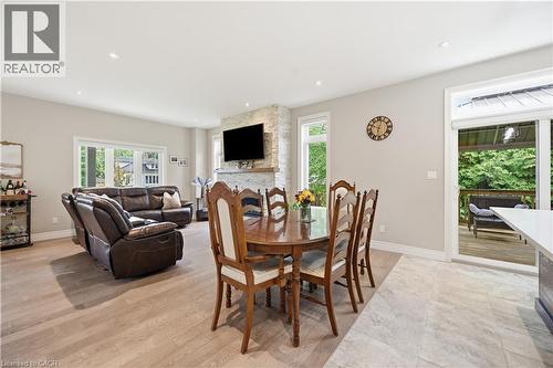 Open-concept interior featuring recessed lighting, a stone-clad fireplace, and expansive windows - 1 Lindsay Way, Grimsby, ON - Indoor