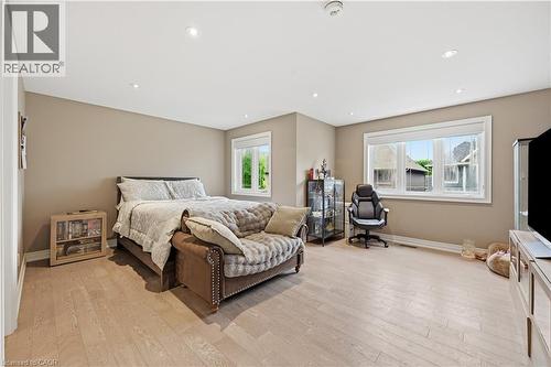 Spacious bedroom featuring light-toned wood-finish flooring, recessed lighting, and neutral wall tones - 1 Lindsay Way, Grimsby, ON - Indoor Photo Showing Bedroom