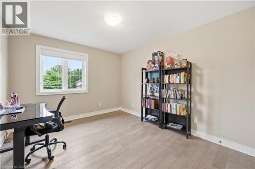 Bright room featuring light wood-finish flooring, neutral-toned walls, a single window with white trim, and a flush-mount ceiling light - 1 Lindsay Way, Grimsby, ON - Indoor Photo Showing Office