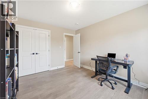 Neutral wall tones, wood-finish flooring, white trim, and a double-door closet with black hardware - 1 Lindsay Way, Grimsby, ON - Indoor Photo Showing Office
