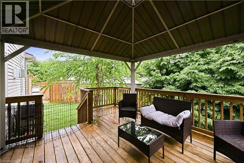 Expansive wood-finish deck featuring a metal-frame gazebo, wood railing, and stairs descending to a fenced yard - 1 Lindsay Way, Grimsby, ON - Outdoor With Deck Patio Veranda With Exterior