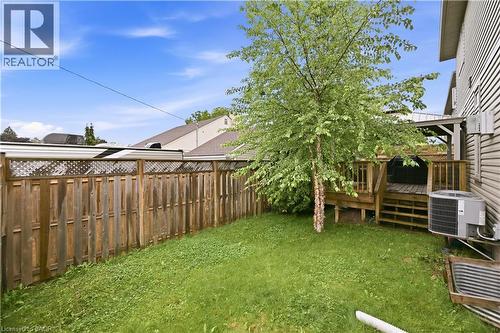 Expansive backyard featuring a manicured lawn, a privacy fence with lattice detailing, and a multi-level wood deck - 1 Lindsay Way, Grimsby, ON - Outdoor
