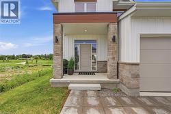 Modern farmhouse exterior featuring vertical white siding and stone accents - 