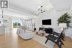 Open-concept living area with light wood-finish flooring - 