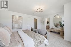 Spacious bedroom featuring light-toned carpeting and white wall finishes - 