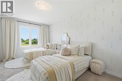 Recessed lighting illuminates this room featuring light-toned carpeting - 