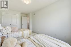 Bright room featuring a flush-mount ceiling light, white walls, and light-colored carpeting - 