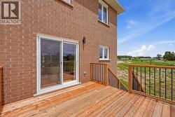 Spacious wood-finish deck with black metal spindle railings and integrated steps - 