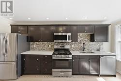 Kitchen dark cabinetry, stainless steel appliances - 