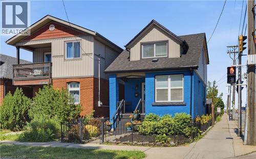 Detached Home featuring a blue brick facade and a dark shingle roof - 309 Cope Street, Hamilton, ON - Outdoor With Facade