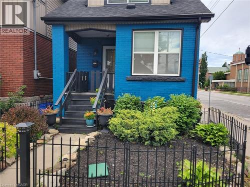 Detached Home featuring a blue brick facade and a dark shingle roof - 309 Cope Street, Hamilton, ON - Outdoor