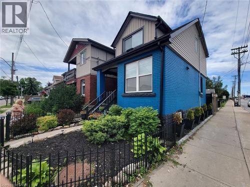 Detached Home featuring a blue brick facade and a dark shingle roof - 309 Cope Street, Hamilton, ON - Outdoor