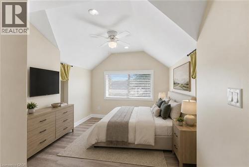 Virtually Staged - Bedroom featuring a vaulted ceiling and a ceiling fan with integrated lighting - 309 Cope Street, Hamilton, ON - Indoor Photo Showing Bedroom