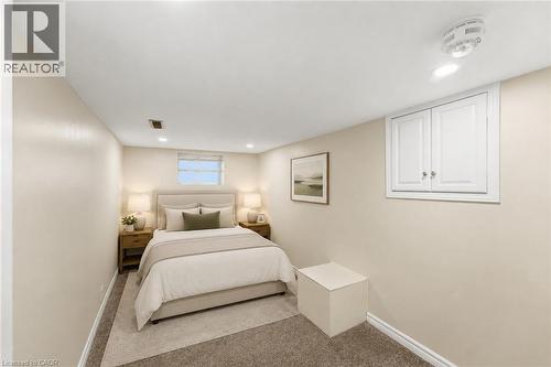Virtually Staged -Bedroom Carpeted entertainment space featuring recessed lighting and a window with blinds - 309 Cope Street, Hamilton, ON - Indoor Photo Showing Bedroom
