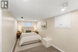Virtually Staged -Bedroom Carpeted entertainment space featuring recessed lighting and a window with blinds - 