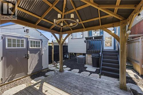 Wood gazebo featuring a corrugated metal roof and an overhead chandelier - 309 Cope Street, Hamilton, ON - Outdoor With Deck Patio Veranda With Exterior