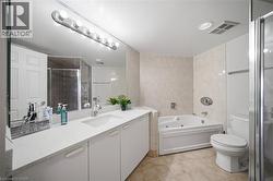 Bathroom featuring a spacious vanity with an integrated sink, a large mirror, and a contemporary light fixture - 