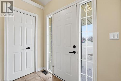 Entryway featuring a paneled door with side-light window, tile flooring, and neutral wall paint - 56 Mccaffery Crescent, St. Catharines, ON 