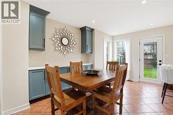 Dining area featuring terracotta-style tile flooring and recessed lighting - 