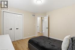 Interior room featuring light wood-finish flooring and neutral wall tones - 