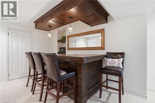 Custom-built wood-finish bar featuring an overhead soffit with recessed lighting and pendant fixtures - 56 Mccaffery Crescent, St. Catharines, ON 