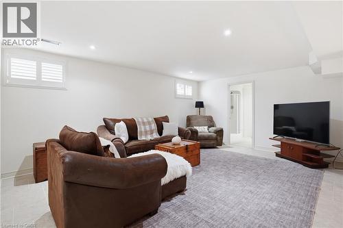 Lower-level living area with recessed lighting, white walls, and light-toned tile flooring - 56 Mccaffery Crescent, St. Catharines, ON 