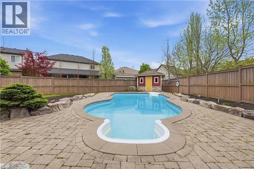 Expansive backyard featuring a large swimming pool with a stone coping, surrounded by a paver patio - 56 Mccaffery Crescent, St. Catharines, ON 