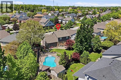 Rear property exterior featuring an in-ground pool, expansive green space, and mature landscaping - 56 Mccaffery Crescent, St. Catharines, ON 