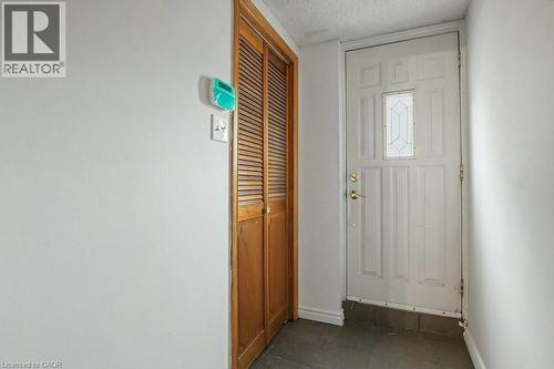 Entryway featuring a paneled door with decorative glass, brass hardware, and durable tile flooring - 396 Pinemeadow Avenue, Mississauga, ON 