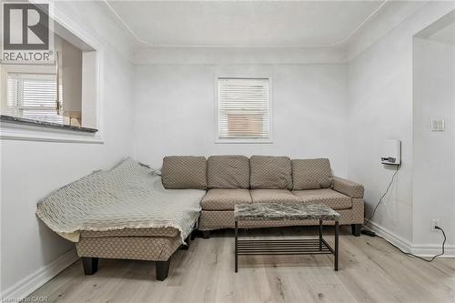 Living space featuring light wood-finish flooring and white painted walls - 43 Whitfield Avenue, Hamilton, ON 