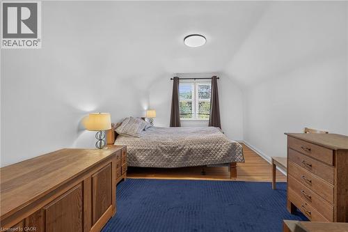 Bedroom featuring hardwood-finish flooring, white walls, and a window with blinds - 83 Aberfoyle Avenue, Hamilton, ON 