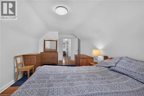 Bedroom featuring sloped ceilings and hardwood flooring - 83 Aberfoyle Avenue, Hamilton, ON 