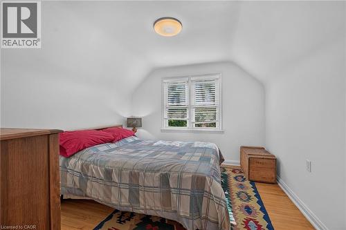Hardwood flooring in a room with white walls and a sloped ceiling - 83 Aberfoyle Avenue, Hamilton, ON 
