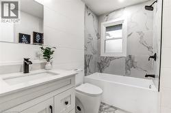 Contemporary bathroom featuring a white vanity with quartz countertop, a white rectangular undermount sink, and matte black fixtures - 