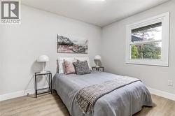 Light-toned wood-finish flooring complements neutral wall tones and white baseboards - 