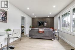 Open concept living area featuring light wood-finish flooring and recessed ceiling lighting - 