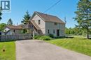 Two-story residential structure with light-colored siding, a dark roof, and multiple windows - 2 Mill Street E, York, ON 
