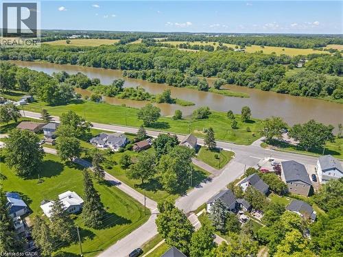 Aerial perspective showcasing a riverside community with residential properties and abundant green spaces - 2 Mill Street E, York, ON 