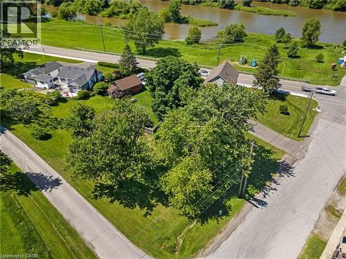 Aerial property view featuring a riverfront setting, multiple residences, and mature trees - 2 Mill Street E, York, ON 