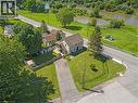 Elevated property featuring a spacious grass yard, mature trees, and an asphalt driveway - 2 Mill Street E, York, ON 