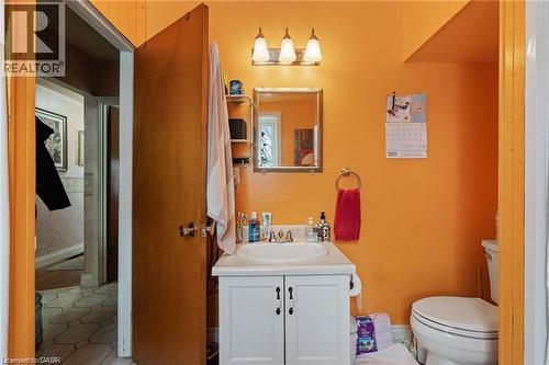 Bathroom featuring a vanity with white cabinetry, a single sink, and a wall-mounted mirror - 2 Mill Street E, York, ON 