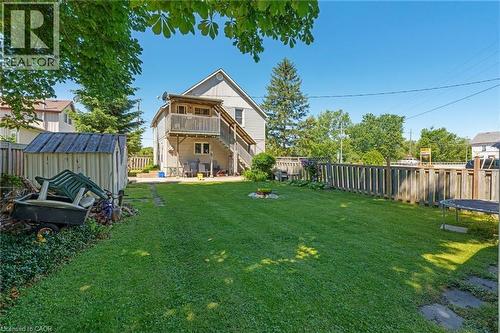 Expansive green lawn with a perimeter wood fence - 2 Mill Street E, York, ON 