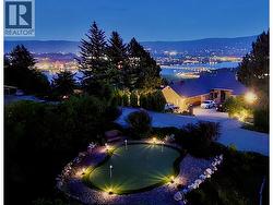 View From The Private Primary Bedroom Balcony Shows The Fun Putting Green Below and Stunning City Night Lights - 