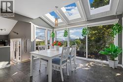 Light-Filled Dining Area With Skylights And Patio Access - 