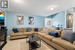Comfortable Basement Lounge Area Perfect For Relaxing or Movie Nights - 