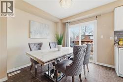 Dining area featuring dark tile flooring and neutral wall tones - 