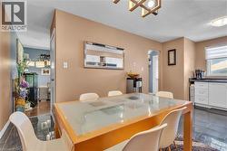 Dining area featuring a prominent wood-finish dining table with a clear top - 