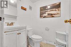 White vanity with integrated sink and brass-finish faucet - 