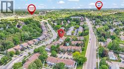Aerial overview of a residential area featuring multiple streets, mature trees, and varying architectural styles - 